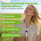 Smiling woman in a sunny field holding a green HOLYMOLY herbal diffuser featuring plant-powered formula benefits